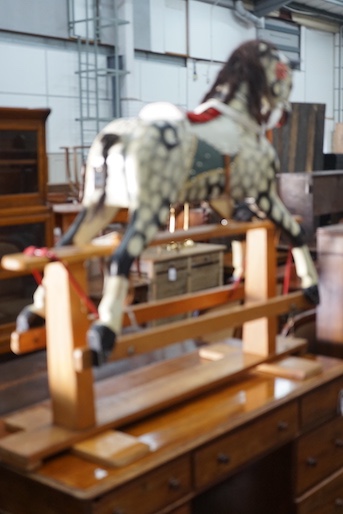 A vintage Ayres type dapple grey carved wood rocking horse on beech safety frame, length 130cm, height 115cm